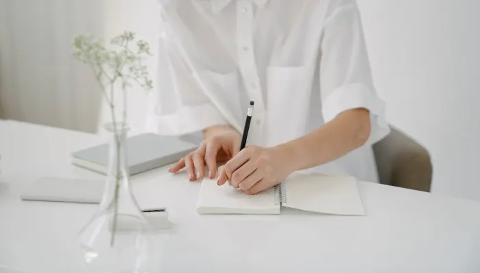 Person writing in white - Why you should start journaling
